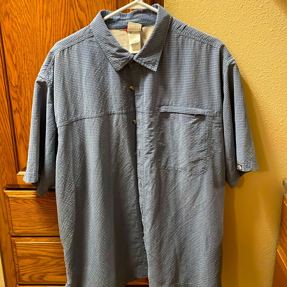 Blue short sleeve North Face light weigh shirt. Slight wear on edges. See pics.